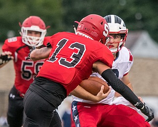 DIANNA OATRIDGE | THE VINDICATOR Struthers' Keith Burnside (13) and Declan Sekol (59)         pursue Niles' Zack Leonard (8) during their game in Struthers on Friday.