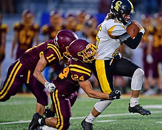 NORGH LIMA, OHIO - SEPTEMBER 7, 2018: Crestview's Stephen Barr fights for yards while being hit by South Range's Anthony DeLucia and Luke Blasko during the first half fo their game, Friday night at South Range High School. DAVID DERMER | THE VINDICATOR