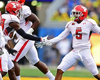 MORGANTOWN, WEST VIRGINIA - SEPTEMBER 8, 2018: Youngstown State's Will Latham, right, celebrates with DJ Smalls after a interception during the first half of their game, Saturday night. DAVID DERMER | THE VINDICATOR