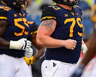 MORGANTOWN, WEST VIRGINIA - SEPTEMBER 8, 2018: West Virginia's Matt Jones jogs onto the field during the first half of their game, Saturday night. DAVID DERMER | THE VINDICATOR