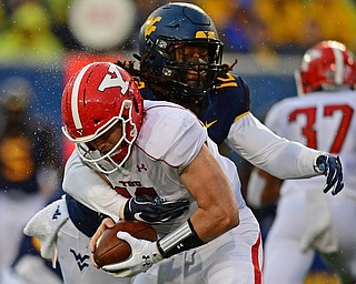 MORGANTOWN, WEST VIRGINIA - SEPTEMBER 8, 2018: Youngstown State's Montgomery VanGorder is tackled for a loss by West Virginia's Jabrill Robinson during the first half of their game, Saturday night. DAVID DERMER | THE VINDICATOR