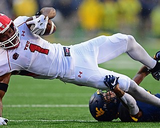 MORGANTOWN, WEST VIRGINIA - SEPTEMBER 8, 2018: Youngstown State's Zach Farrar is tackled by West Virginia's Derek Pitts Jr. during the first half of their game, Saturday night. DAVID DERMER | THE VINDICATOR