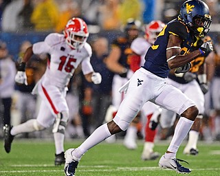 MORGANTOWN, WEST VIRGINIA - SEPTEMBER 8, 2018: West Virginia's Dominique Maiden runs away from he Youngstown State defense and into the end zone to score a touchdown during the second half of their game, Saturday night. West Virginia won 52-17. DAVID DERMER | THE VINDICATOR