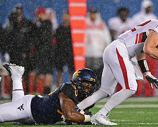 MORGANTOWN, WEST VIRGINIA - SEPTEMBER 8, 2018: Youngstown State's Montgomery VanGorder is sacked by West Virginia's Darius Stills during the second half of their game, Saturday night. West Virginia won 52-17. DAVID DERMER | THE VINDICATOR