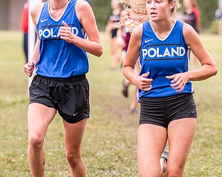 DIANNA OATRIDGE | THE VINDICATOR Poland's Emily Denney (left) and Sydney Norris (right) compete at the Suburban Cross Country meet at Austintown Park on Tuesday.