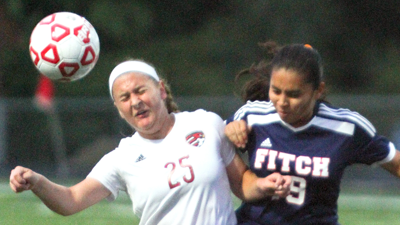 Canfield’s Hannah Stein (25) and Austintown Fitch’s Jackie Arroyo (19) battle for control of the ball during a game Wednesday night, Canfield won, 7-0.