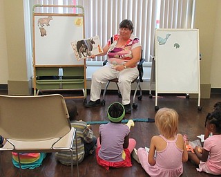 Neighbors | Jessica Harker.Librarian Karen Saunders read "Moo Moo Brown Cow," to the group of children gathered at the monthly playtime event August 15 at the Boardman library.