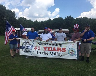 Neighbors | Submitted.Representatives from West Side Tire led the float with a banner, celebrating the businesses 40 years in the Mahoning Valley. The float won best commercial float for the parade.