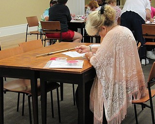 Neighbors | Jessica Harker.Participants worked on their needle work projects at the Poland library August 21.