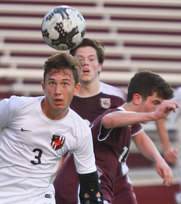 William D. Lewis The Vindicator Howland's Francis Cesta(3) heads the ball as Boardman's Brian Yauger and Trevor Boggess defend during 9-13-18 action at Boardman.