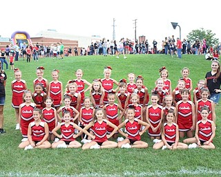 Neighbors | Abby Slanker.Canfield Little Cardinals Pee Wee cheerleaders, under the direction of coach Holly Harrington (left) and Reagan Meusborn (right), performed at the annual Canfield Community Tailgate prior to the Canfield Cardinals versus Chardon varsity football game on Sept. 7.
