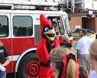 Neighbors | Abby Slanker.Canfield’s school mascot, Big Red, arrived at the Canfield Community Tailgate on a Cardinal Joint Fire District fire truck with lights flashing and sirens blaring.