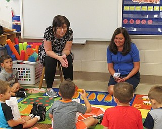 Neighors | Jessica Harker .Teachers Terry Wittenauer and Diana Weaver listened as students shared their personal items in their "me bag" Sept. 7 at Poland Union Elementary.