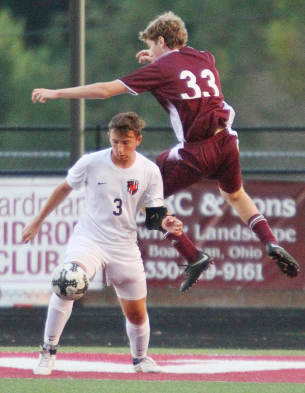 William D. Lewis The Vindicator  Boardman's Chris Barber(33) and Howland's Francis Cesta(3) during 9-13-18 action at Boardman.