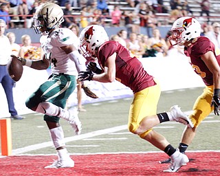 St. Vincent-St. Mary's Terrance Keyes, Jr. gets past Cardinal Mooney's Mike Scavina and Andrew Armile and crosses the end zone to score a touchdown during the first half of their game at Stambaugh Stadium on Friday night. EMILY MATTHEWS | THE VINDICATOR