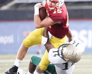 Cardinal Mooney's John Murphy gets tackled by St. Vincent-St.Mary's Jahiem Peake during the first half of their game in Stambaugh Stadium on Friday night. EMILY MATTHEWS | THE VINDICATOR