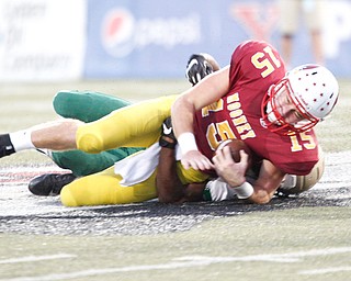 Cardinal Mooney's John Murphy gets tackled by St. Vincent-St.Mary's Jahiem Peake during the first half of their game in Stambaugh Stadium on Friday night. EMILY MATTHEWS | THE VINDICATOR