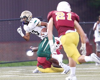 St. Vincent-St.Mary's Joshua Jones gets past Cardinal Mooney during the first half of their game in Stambaugh Stadium on Friday night. EMILY MATTHEWS | THE VINDICATOR