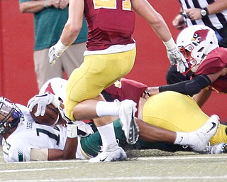 St. Vincent-St.Mary's Joshua Jones gets tackled by Cardinal Mooney's Luke Fulton during the first half of their game in Stambaugh Stadium on Friday night. EMILY MATTHEWS | THE VINDICATOR