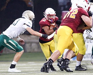 Cardinal Mooney's Chris Gruber tries to get past St. Vincent-St.Mary's Anthony Ward during the first half of their game at Stambaugh Stadium on Friday night. EMILY MATTHEWS | THE VINDICATOR