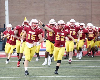 Cardinal Mooney runs onto the field at the start of their game against St. Vincent-St. Mary at Stambaugh Stadium on Friday night. EMILY MATTHEWS | THE VINDICATOR