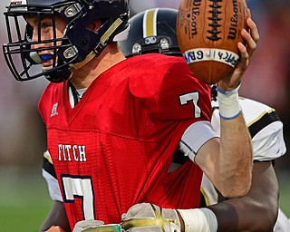 AUSTINTOWN, OHIO - SEPTEMBER 14, 2018: Fitch's Bobby Cavalier looks to throw the ball away while being wrapped up by Harding's Jaquahn Mcintosh during the first half of their game, Friday night at Austintown Fitch High School. DAVID DERMER | THE VINDICATOR
