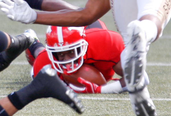 Youngstown's Samuel St. Surin holds onto the ball as he falls during the first half of their game against Valparaiso on Saturday at Stambaugh Stadium. EMILY MATTHEWS | THE VINDICATOR