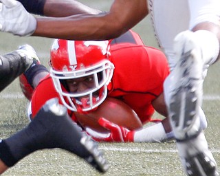 Youngstown's Samuel St. Surin holds onto the ball as he falls during the first half of their game against Valparaiso on Saturday at Stambaugh Stadium. EMILY MATTHEWS | THE VINDICATOR