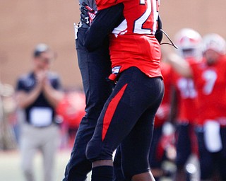 Youngstown's Natavious Payne celebrates with wide receivers coach Tim Marlowe after scoring a touchdown during the first half of their game against Valparaiso on Saturday at Stambaugh Stadium. EMILY MATTHEWS | THE VINDICATOR