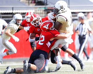 Youngstown's Armand Dellovade (42) and Jakkar Jackson tackle Valparaiso's Jean Rene during the first half of their game on Saturday at Stambaugh Stadium. EMILY MATTHEWS | THE VINDICATOR