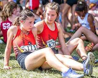 DIANNA OATRIDGE | THE VINDICATOR Canfields' Maddie Ritter (left) and Steffie Marciniak (right) sit down to rest after completing their races at the Boardman Spartan Invitational Cross Country meet at Boardman High School on Saturday.