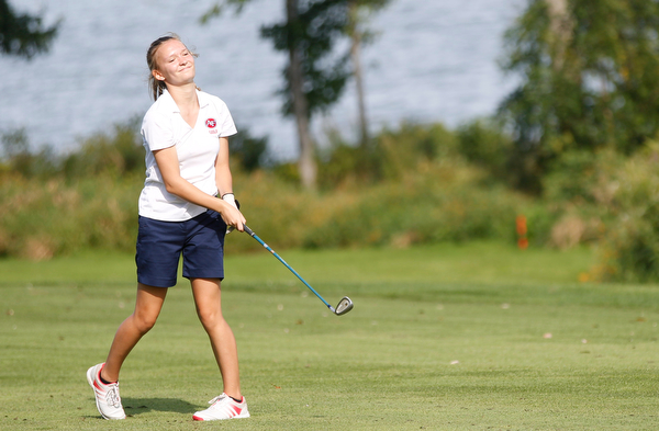 Cammille Hagan, with the Austintown Fitch girls golf team, reacts after she hits her ball during the Christine Terlesky Lake Club Girls High School Golf Invitational on Sunday. EMILY MATTHEWS | THE VINDICATOR