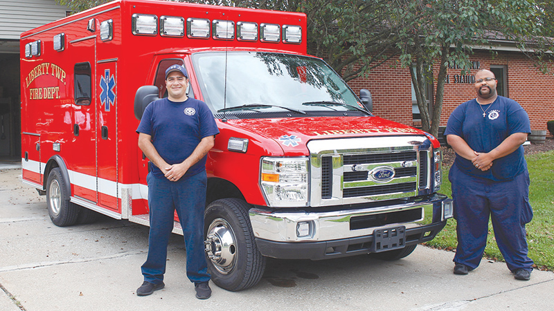 Ronald Womack, left, of Liberty, and Ronnie Simone, of Warren, fi refi
ghters with the Liberty Township Fire Department, stand next to
the township’s new ambulance parked in front of the fi re station.