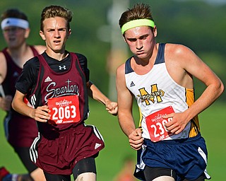 CANFIELD, OHIO - SEPTEMBER 19, 2018: McDonald's Zach Canada, right, and Boardman's Anthony Marshall run to the finish line during the 2018 Suburban Cross Country meet, Wednesday afternoon at the Canfield Fairgrounds. DAVID DERMER | THE VINDICATOR