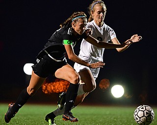 YOUNGSTOWN, OHIO - SEPTEMBER 19, 2018: Mooney's Bre Evans, left, battles with Ursuline's Caroline Aey during Wednesday nights game at the Youngstown State Soccer complex. DAVID DERMER | THE VINDICATOR