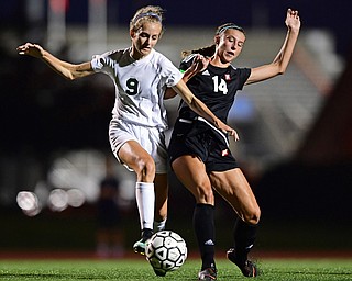 YOUNGSTOWN, OHIO - SEPTEMBER 19, 2018: Mooney's Bre Evans, right, battles with Ursuline's Caroline Aey during Wednesday nights game at the Youngstown State Soccer complex. DAVID DERMER | THE VINDICATOR