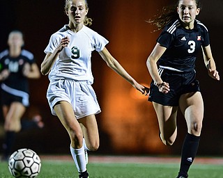 YOUNGSTOWN, OHIO - SEPTEMBER 19, 2018: Ursuline's Caroline Aey chases the ball with Mooney's Lucy Graziano during Wednesday nights game at the Youngstown State Soccer complex. Wollet would score on the play. DAVID DERMER | THE VINDICATOR