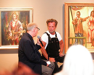 John Mellencamp, right, answers questions from Dr. Louis Zona, the Executive Director and Chief Curator of the Butler Institute of American Art, during the reception of the exhibit John Mellencamp: Expressionist, which features many of Mellencamp's most recent artworks, at The Butler Institute of American Art on Thursday. EMILY MATTHEWS | THE VINDICATOR