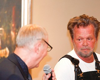 John Mellencamp, right, answers questions from Dr. Louis Zona, the Executive Director and Chief Curator of the Butler Institute of American Art, during the reception of the exhibit John Mellencamp: Expressionist, which features many of Mellencamp's most recent artworks, at The Butler Institute of American Art on Thursday. EMILY MATTHEWS | THE VINDICATOR