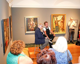 John Mellencamp answers questions from Dr. Louis Zona, the Executive Director and Chief Curator of the Butler Institute of American Art, in front of a crowd during the reception of the exhibit John Mellencamp: Expressionist, which features many of Mellencamp's most recent artworks, at The Butler Institute of American Art on Thursday. EMILY MATTHEWS | THE VINDICATOR