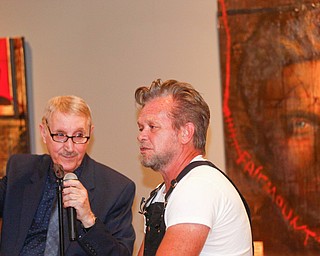 John Mellencamp, right, answers questions from Dr. Louis Zona, the Executive Director and Chief Curator of the Butler Institute of American Art, during the reception of the exhibit John Mellencamp: Expressionist, which features many of Mellencamp's most recent artworks, at The Butler Institute of American Art on Thursday. EMILY MATTHEWS | THE VINDICATOR