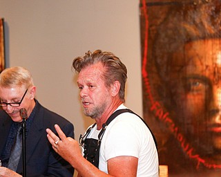 John Mellencamp, right, answers questions from Dr. Louis Zona, the Executive Director and Chief Curator of the Butler Institute of American Art, during the reception of the exhibit John Mellencamp: Expressionist, which features many of Mellencamp's most recent artworks, at The Butler Institute of American Art on Thursday. EMILY MATTHEWS | THE VINDICATOR