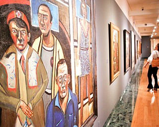 People look at different pieces of art by John Mellencamp, including his 2018 oil painting We Forget It Was Sunday, left, during the reception of the exhibit John Mellencamp: Expressionist at The Butler Institute of American Art on Thursday. EMILY MATTHEWS | THE VINDICATOR