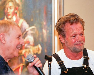 John Mellencamp, right, answers questions from Dr. Louis Zona, the Executive Director and Chief Curator of the Butler Institute of American Art, during the reception of the exhibit John Mellencamp: Expressionist, which features many of Mellencamp's most recent artworks, at The Butler Institute of American Art on Thursday. EMILY MATTHEWS | THE VINDICATOR