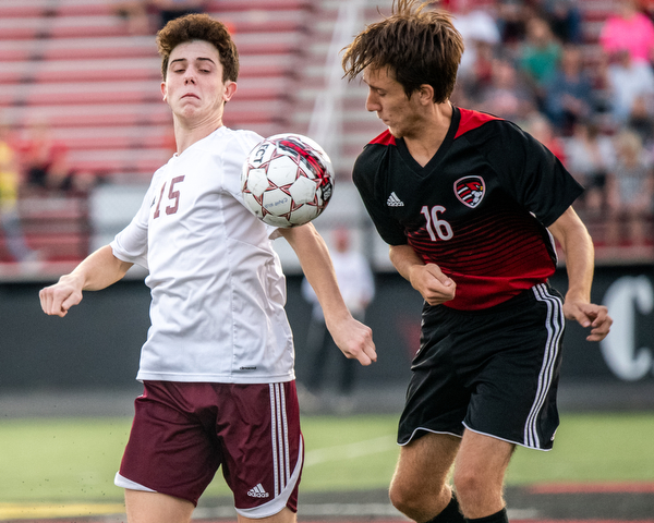 DIANNA OATRIDGE | THE VINDICATOR Boardman's Trevor Boggess (15) and Canfield's Matt Beck (16) battle for possession of the ball during their game at Bob Dove Field in Canfield on Thursday. The Spartans won the AAC match up 4-1.
