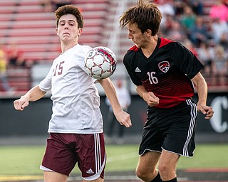 DIANNA OATRIDGE | THE VINDICATOR Boardman's Trevor Boggess (15) and Canfield's Matt Beck (16) battle for possession of the ball during their game at Bob Dove Field in Canfield on Thursday. The Spartans won the AAC match up 4-1.