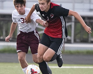 DIANNA OATRIDGE | THE VINDICATOR Boardman's Jake Hughes (36) and Canfield's Aren Villano(7) pursue the ball during their game at Bob Dove Field in Canfield on Thursday. The Spartans won the AAC match up 4-1.