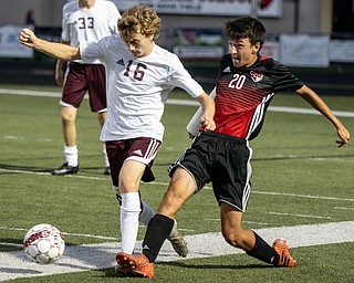 DIANNA OATRIDGE | THE VINDICATOR Boardman's Dom Barber (16) and Canfield's Nick Hartman (20) pursue the ball during their game at  Bob Dove Field in Canfield on Thursday. The Spartans won 4-1.