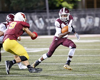 Boardman's Che Trevena tries to get around Cardinal Mooney's Jason Santisi during their game at Stambaugh Stadium on Friday. EMILY MATTHEWS | THE VINDICATOR