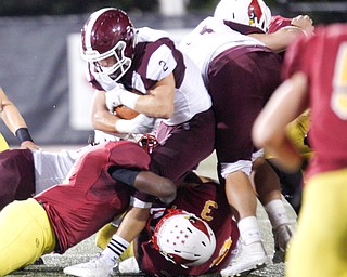 Boardman's Joe Ieraci gets tackled by Cardinal Mooney during their game at Stambaugh Stadium on Friday. EMILY MATTHEWS | THE VINDICATOR